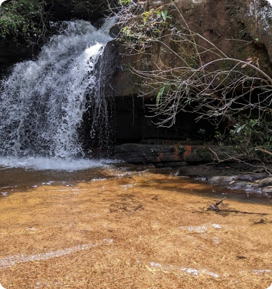 uma das cachoeiras da trilha com uma pequena queda de água e muito volume.